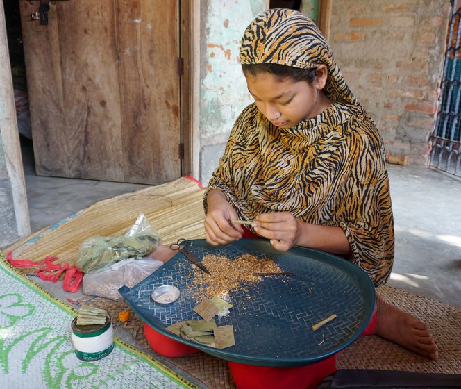 Julekha Khatun is in Class 9 and rolls beedis to support her studies.