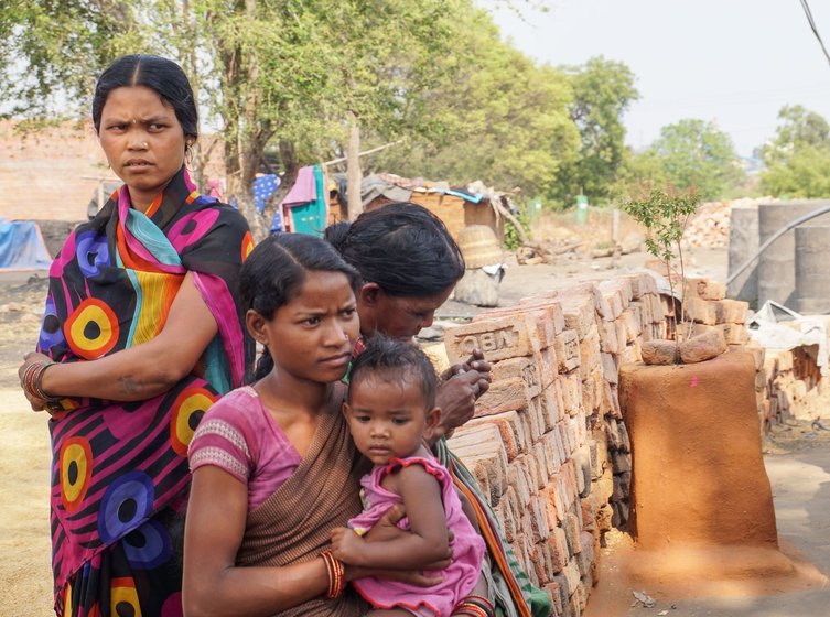 Left: Joyanti Parabhue (standing) with other workers. Right: Kirmani (in blue), Joyanti, Anjoli and Bosanth (in background), in the cooking area of Joyanti's hut