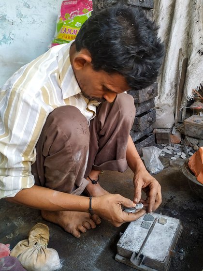 Left: Placing master tokens inside the mould. Centre: Stepping on the peti to compress the soil. Right: Refining the impressions, making way for the molten liquid