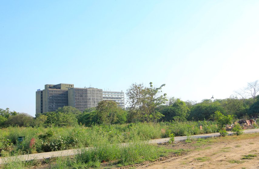 Left: From across the graveyard, you can see the building of the Delhi police headquarters at ITO. Right: Nizam has been printing names of the deceased on these gravestones for over 40 years