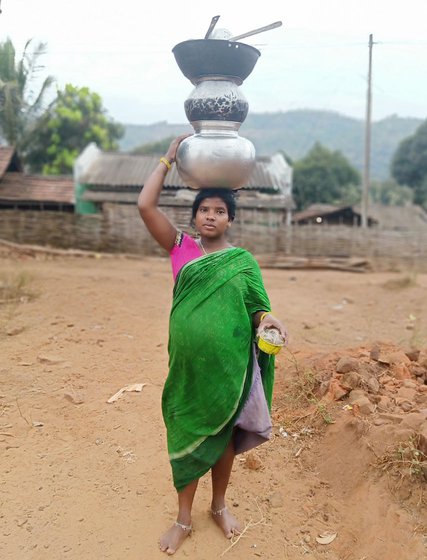 Kusama Naria (left), nearly nine months pregnant, walks the plank to the boat (right, in red saree) for Chitrakonda to get corrections made in her Aadhaar card