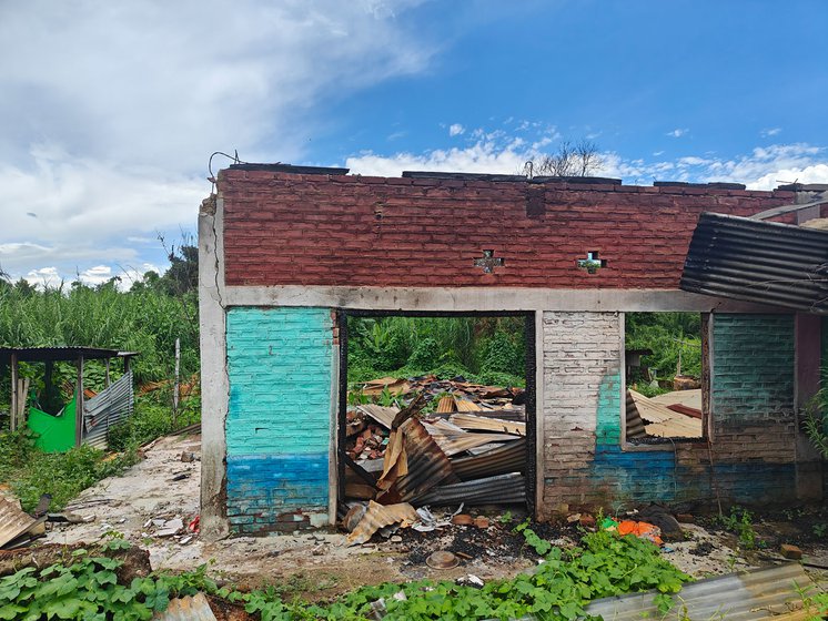 A home (left) and a shop (right) burned to the ground near the border of Imphal and Churachandpur, Manipur