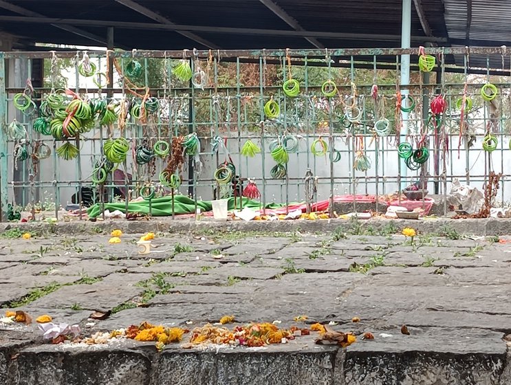 Left: Women who are seeking a match for their daughters tie bunches of light green or neon bangles to a metal fence behind the mazar.