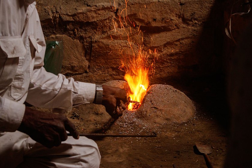 Heating the iron in a forge is challenging as it can cause severe burns, says Mohanlal. Kaluji (right), Mohanlal’s son-in-law, helping him hammer the red-hot iron