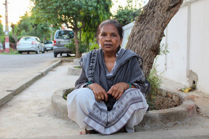 Ramvati in the colony where she does domestic work. With the kiosk (right) shut during the lockdown, the household had run on her earnings