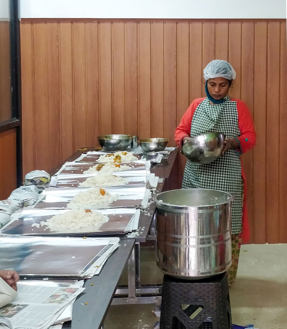 Left: Rice is packed in coated paper. Right: A. Rajeev with his meal packets. 'I hope they will continue even after the lockdown'

