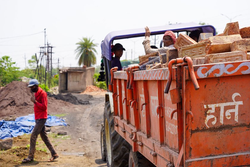 Right: Workers leaving in trucks carrying bricks to be supplied to customers