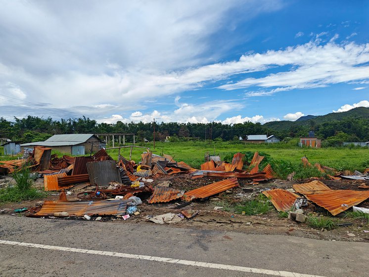 A home (left) and a shop (right) burned to the ground near the border of Imphal and Churachandpur, Manipur