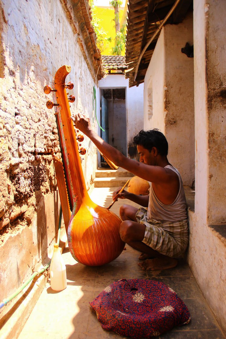 Right: Finishing touches being made on the veenai in the passageway next to Narayanan’s workshop