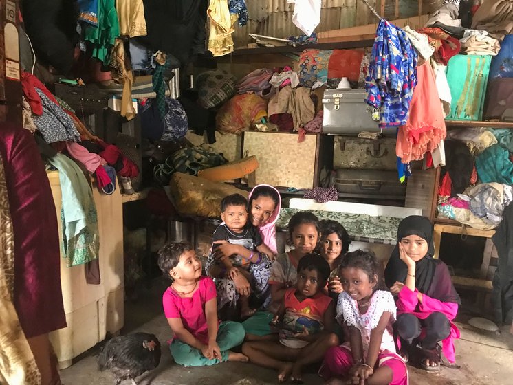 Kitabun with her daughter-in-law Zahida (left), who looks after the 11 children (right) of the family