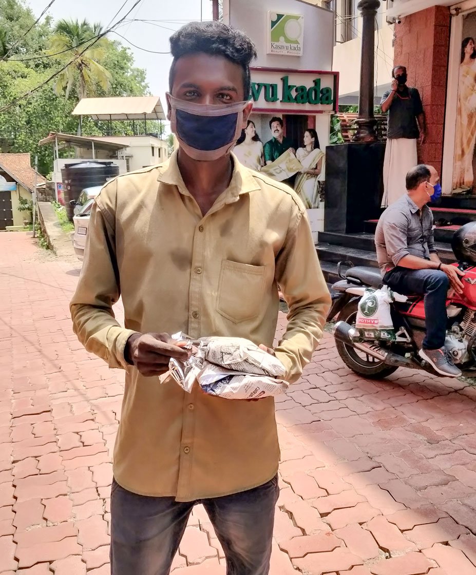 Left: Rice is packed in coated paper. Right: A. Rajeev with his meal packets. 'I hope they will continue even after the lockdown'

