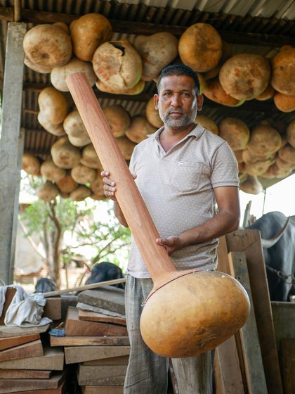 Right: Imtiaz Sitarmaker poses with the sitar structure he has made. He is responsible for the first steps of sitar- making