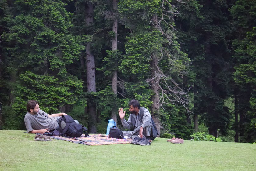 Dr. Shaikh Ghulam Rasool (left) and a resident of Mujpathri (right) discussing their claim submitted by the Forest Rights Committee (FRC) of the village