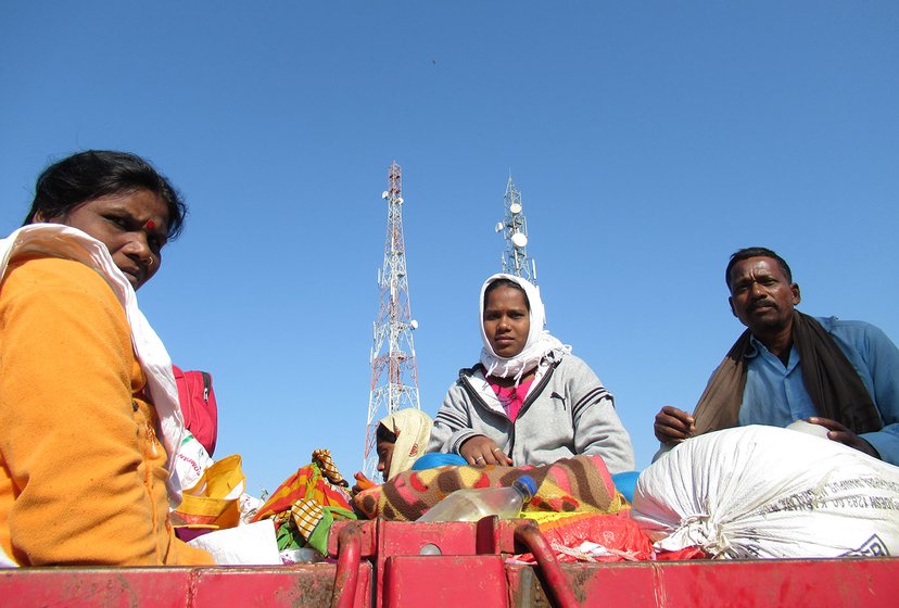 A family sitting on top of a trailer