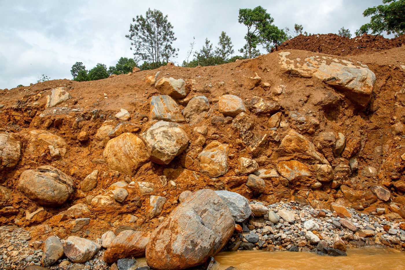 The land is a mix of soil and rock, and when saturated with heavy rain became unstable, contributing significantly to the disaster