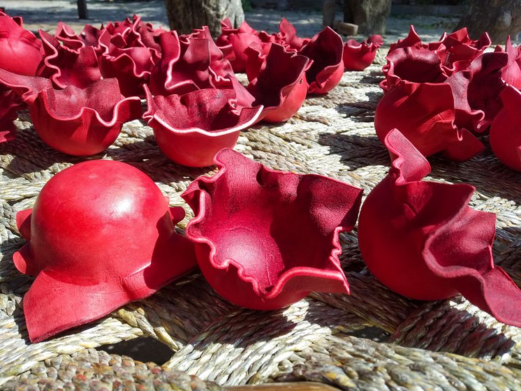 Left: Heat-pressed hemispheres for two-piece balls are left to dry in the sun.