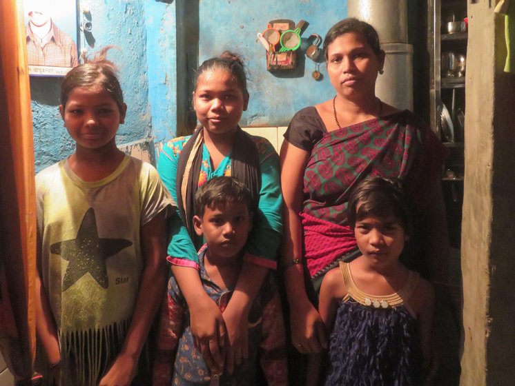 Archana Chabuskwar and her family (left) in their home in the Anand Nagar slum colony and (right) a photograph of her deceased husband Rajendra: 'How do we clean hands constantly? The water comes here every two days. And who can afford that liquid [hand sanitiser]?'

