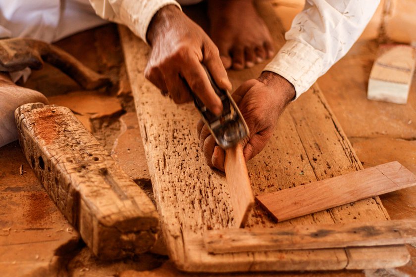 Using a randa , he smoothens (left) the surface of the wood, then rounds the corners of the khartals (right) using a coping saw