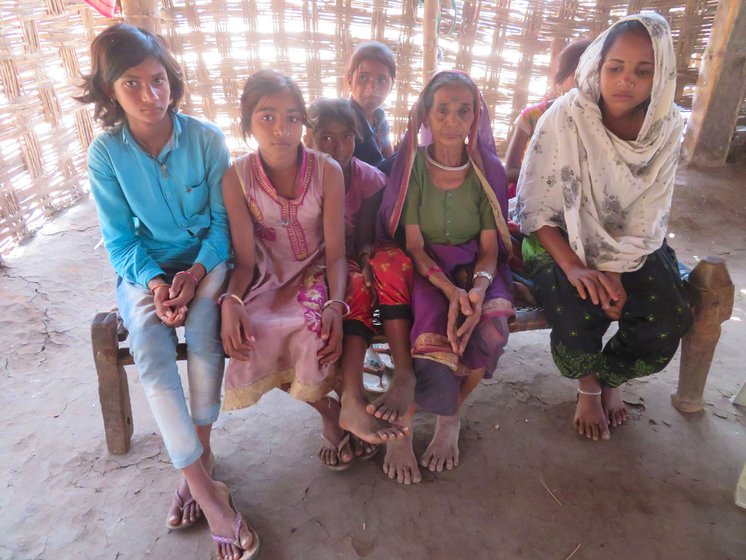 Bubali, 82, with her grandkids in the remote Chitkhedi hamlet. She and her husband are in an age bracket eligible for the vaccine, but, she says, 'Why should we be happy about the vaccine when we can’t walk to get one?'