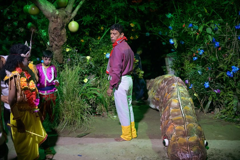 Left: Backstage at the Garamur Saru Satra, Dutta prepares to perform the role of Aghasura, a serpent demon.