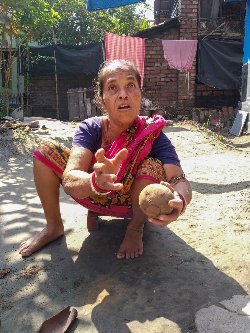 Minoti (right) demonstrating the task of glazing a polo ball with sand paper. 'Between housework, I used to do the smoothening and finishing,' she says