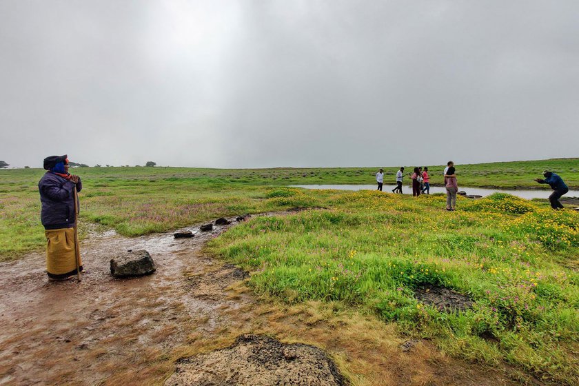 Laxman Shinde (left) from Vanjolwadi collects plastic and non-disposable debris on Kaas during the flowering season. Ironically, it is the tourism that has opened seasonal employment opportunities between August and October for Laxman, Sulabai (right) and others from the surrounding villages