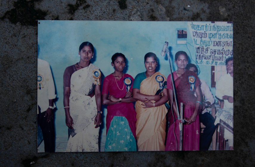 A photograph from of a young Shanthi akka (wearing a white saree) performing Villu Paatu, a traditional form of musical storytelling, organised by Schizophrenia Research Foundation. She worked with SCARF for 30 years.