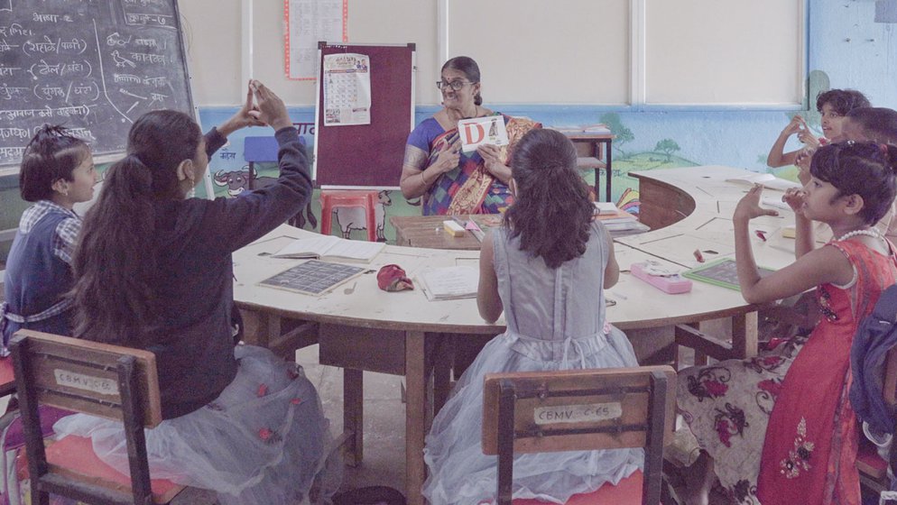 At the Dhayari School for the Hearing Impaired, Aditi Sathe (left) using picture cards . Sunita Zine (right) is the hostel superintendent and is teaching colours and Marathi alphabets to the youngest students