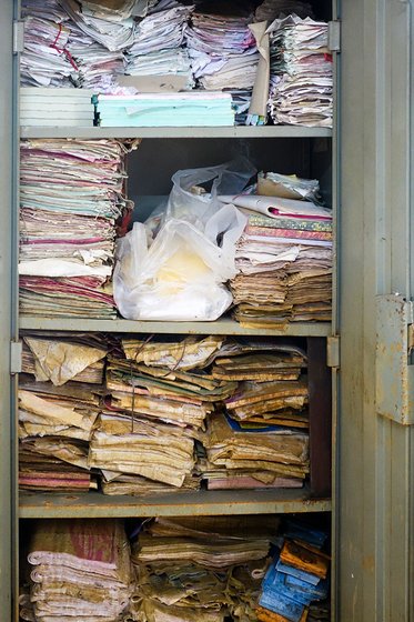 Documents and books stacked in a cupboard 