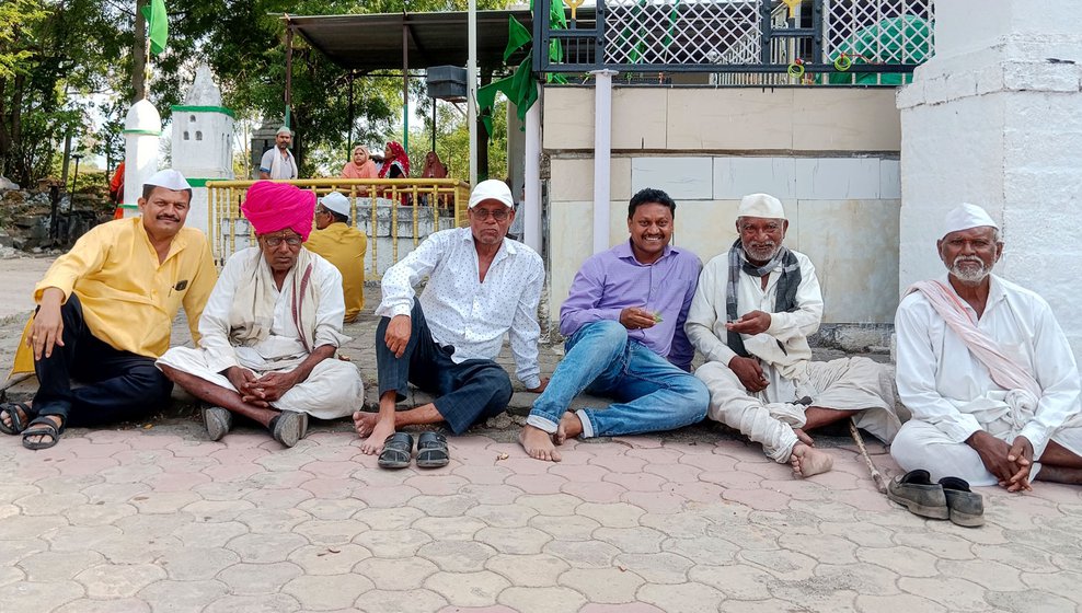 Left: Men sitting and chatting after the feast, sharing a paan and some laughs.