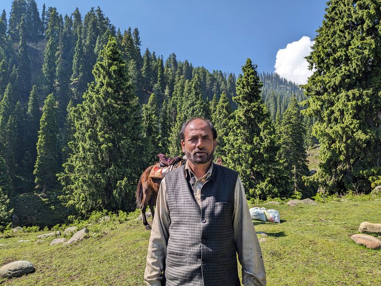 Mohammed Younus (left) on the banks of the Shaliganga river in Doodhpathri where he and his family have come with their livestock. They will continue to move upstream till the source of the river in search of fresh pastures. Inside their tent, (in the front) his spouse Zubeda Begam and his brother (with the hookah)