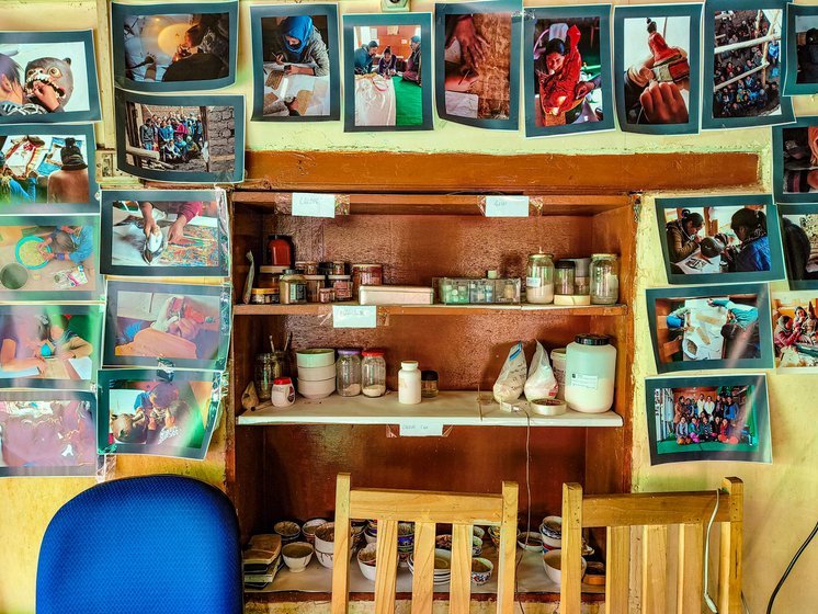 Right:  A part of the workshop where raw materials for the paintings are stored. Also seen are photographs from HAP’s earlier exhibitions