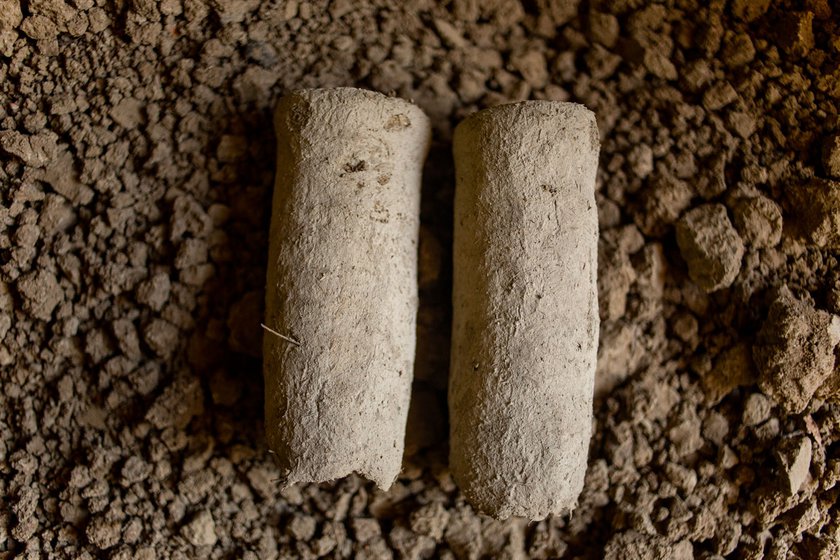 The clay is shaped into the idol's legs using a pestle (left) which has been in the family for many generations. The clay legs are kept to dry in the shade (right)