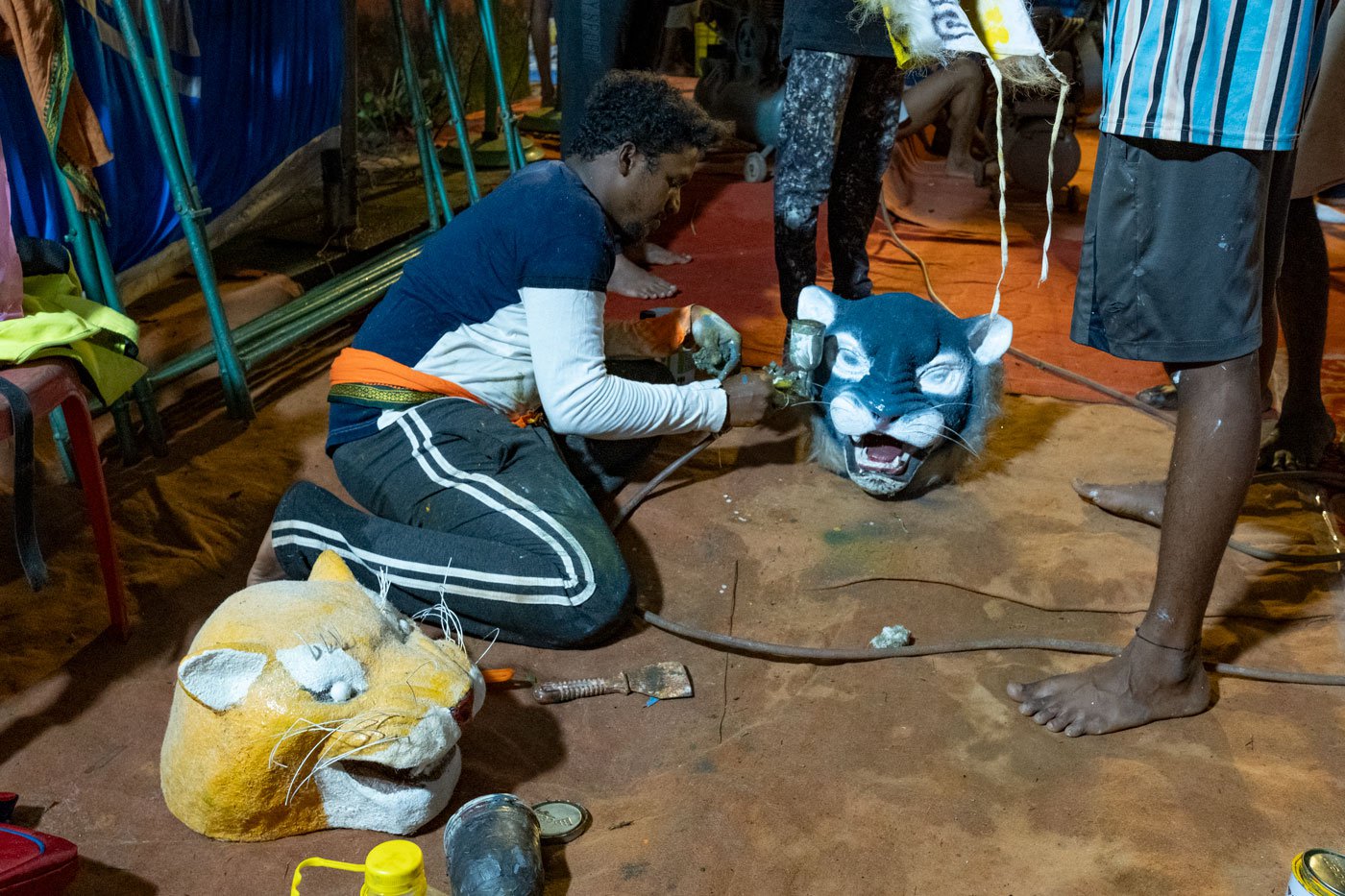 During pili vesha performance, the dancers growl and dance wearing tiger masks which are also hand painted