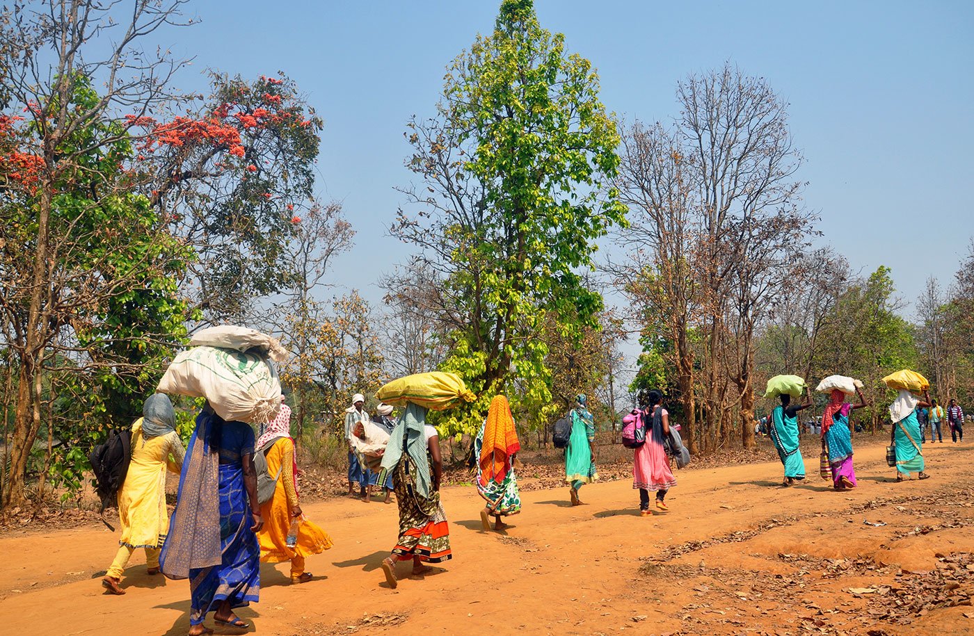 Women carrying headloads are also at the festival