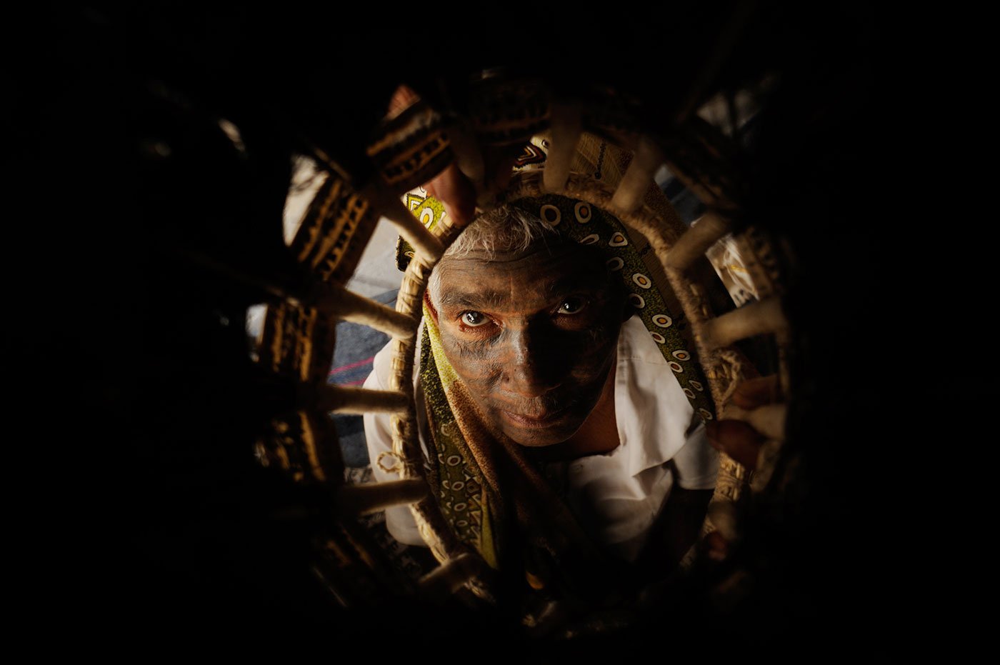 Woman looking through her head dress