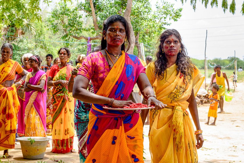 K. Kanniamma and S. Amaladevi carrying rice mixed with blood of a slaughtered goat and rooster (left).