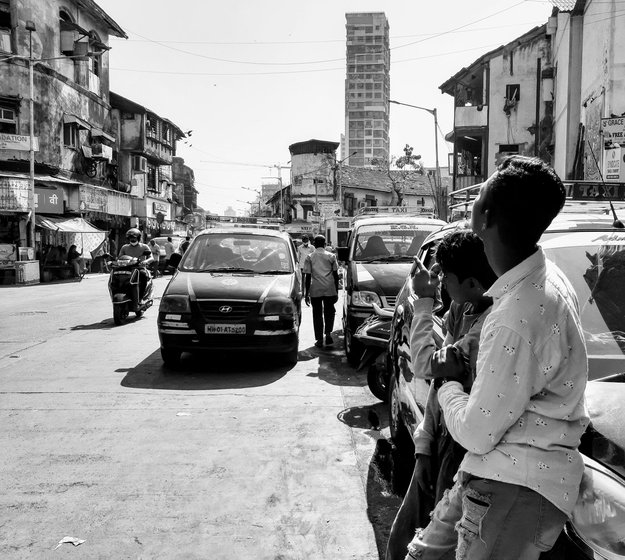 The teenager's immediate world: the streets of the city, and the narrow passageway in the brothel building where he sleeps. In future, Vikram (left, with a friend) hopes to help sex workers who want to leave Kamathipura

