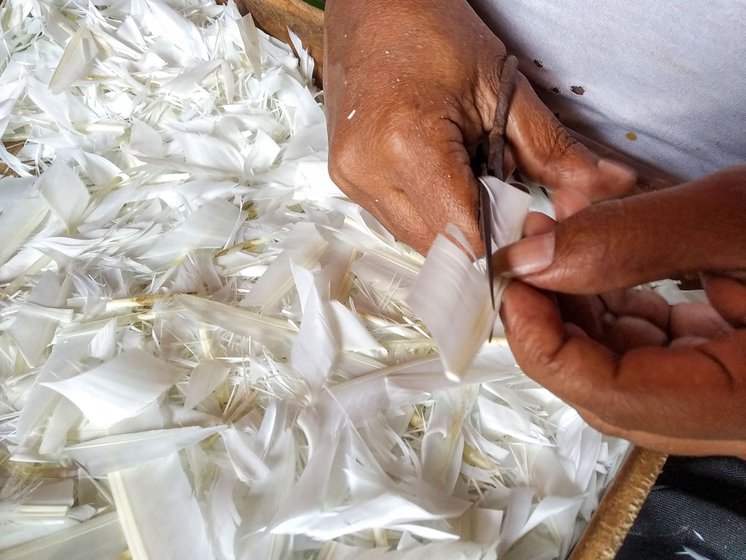 Right: Prahlad Pal shapes the feathers with pair of handheld iron scissors