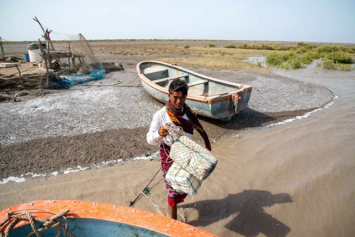 Aadam Jat holding his homemade polystyrene float, which helps him when swims with his animals