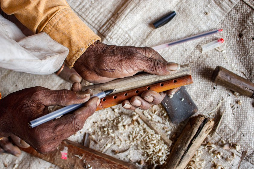 Narayan marks the reference for tone holes on a plastic pirn used in power looms to ensure no mistakes are made while drilling the holes. 'Even a one-millimetre error produces a distorted pitch,' he says