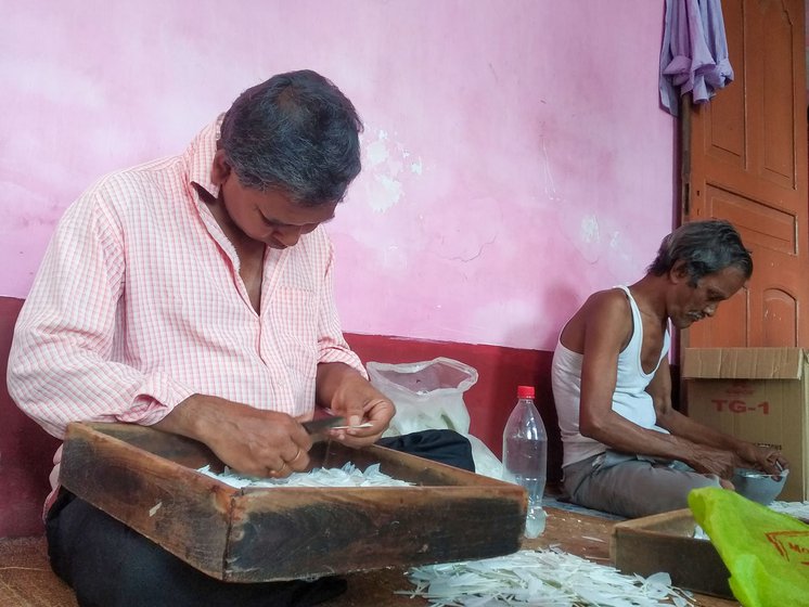 Montu Partha (left) along with Bhabani Adhikari and Likhan Majhi (right) shape the trimmed feathers