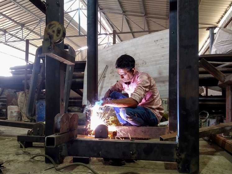 Right: He uses an arc welder to work on the base of the multi-gym