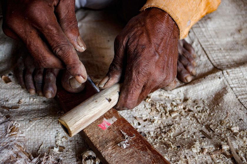 Narayan marks the reference for tone holes on a plastic pirn used in power looms to ensure no mistakes are made while drilling the holes. 'Even a one-millimetre error produces a distorted pitch,' he says