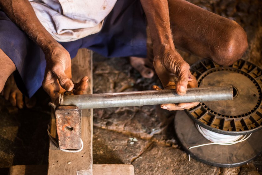 Bapu setting up the winding machine before rewinding it.