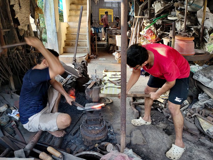 Right: His son Om helps out in the workshop