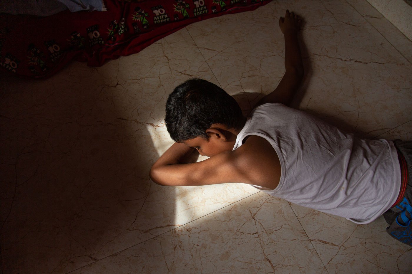 Manase asleep on the floor in the house in Gummidipoondi