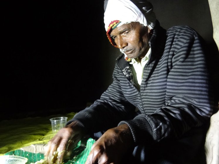 Dadaji (left) and Ramchandra lit a bonfire to keep warm on a cold winter night during a night vigil