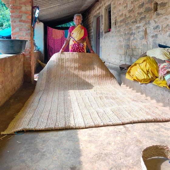 The verandah of Jolen's house, built with her savings, is used to make chatais and is also a gathering place for neighbours