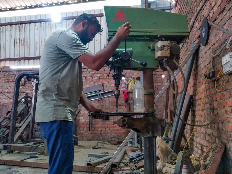 Amir uses a hand operated drilling machine (left) to make a hole into a plate that will be welded onto the multi-gym. Using an arc welder (right), he joins two metal pieces